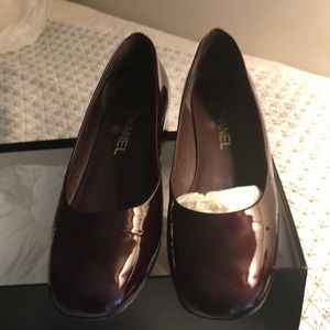 A Pair Of Patent Chanel Shoes